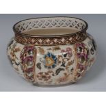 A Zsolnay Pecs oval jardiniere, decorated in polychrome with flowers picked out in gilt,