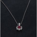 A ruby and diamond pendant necklace, central oval red ruby approx 0.