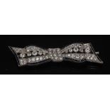 A diamond and sapphire tied ribbon bow brooch, pave set with sixty six round old cut diamonds,