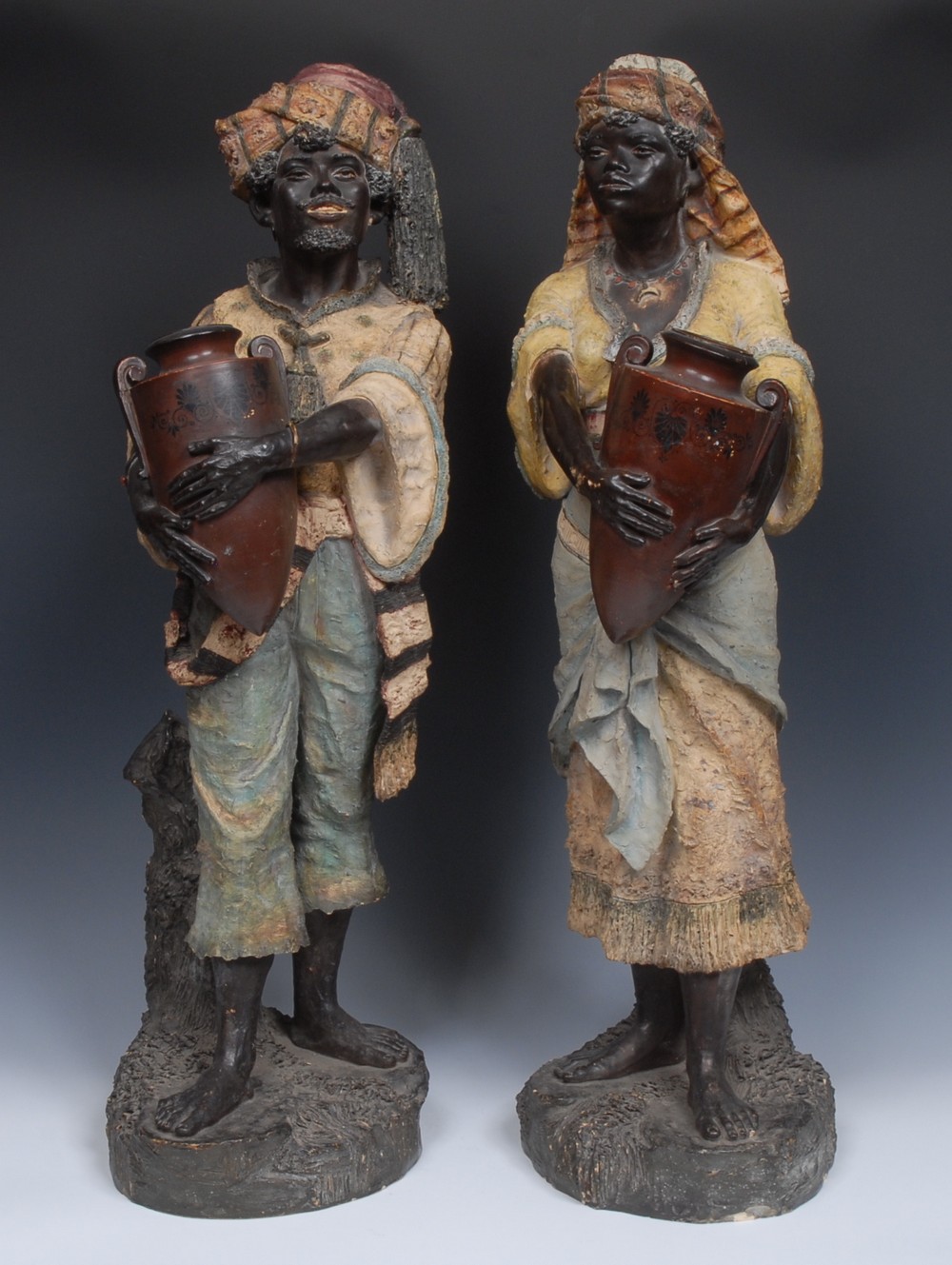 A large pair of early 20th century Austrian earthenware figures, of Nubian Water Carriers,