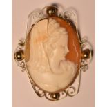 A carved shell cameo brooch, maiden with hair up, wearing a double strand necklace and bustier,