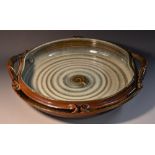 An impressive studio pottery dish, tenmoku glaze, indistinctly marked, 40cm wide.