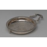 A George III provincial silver lemon strainer, everted rim, leafy lug handle, moulded rest, 14.