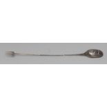 An 18th century silver coloured metal sucket fork, pierced mote spoon bowl, twisted haft,