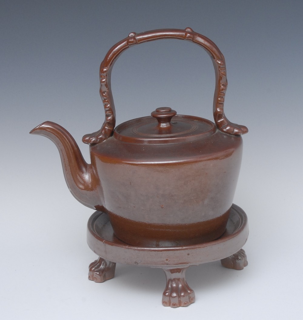 A Brampton brown saltglazed stoneware tea kettle on stand, paw feet, 29cm high, c.