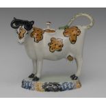 A Pratt Ware cow creamer and cover,