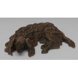 An early 20th century Austrian cold-painted bronze, of a dozing spaniel,