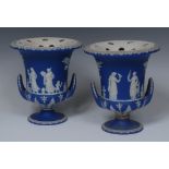 A pair of Wedgwood jasperware campana pot pourri vases, sprigged in white with Classical figures,