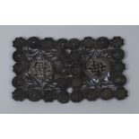 A Chinese silver shaped rectangular buckle, pierced, embossed and applied with characters,