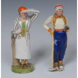 A Royal Crown Derby figure, Lady Golfer, she stands wearing an orange berry and striped jacket,