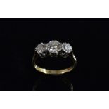 A diamond trilogy ring, central round brilliant cut diamond approx 0.