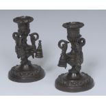 A pair of Regency dark patinated bronze candlesticks,