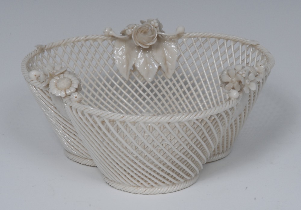 A Belleek trefoil three-stand basket, rope twist border applied with three flowers sprigs,