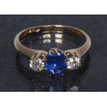 A sapphire and diamond trilogy ring, central blue sapphire approx 1.