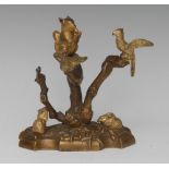 A post-Regency gilt patinated bronze desk group, cast as a tableau from the natural world,