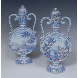 A pair of Dutch Delft two-handled moon flasks and covers, decorated with a mother and her children,