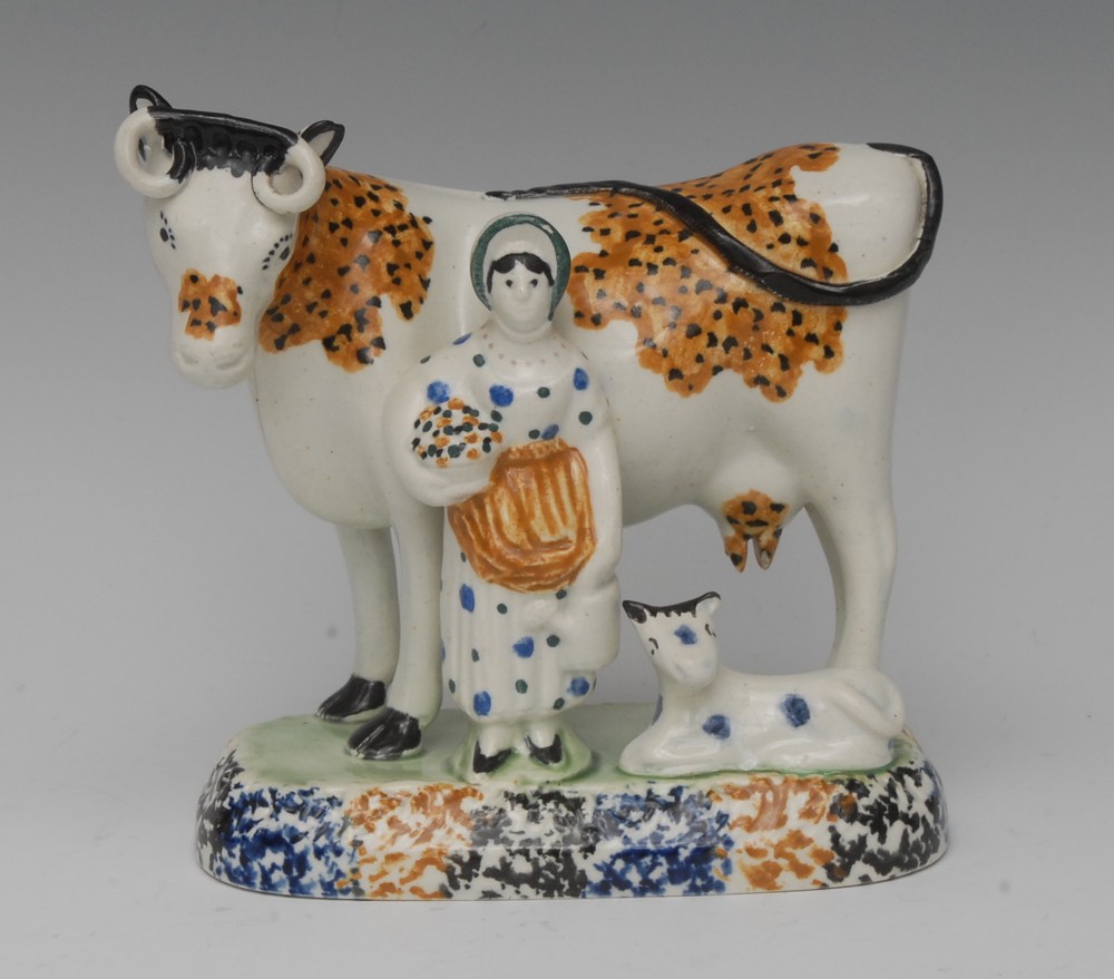 A James Emery Pottery Mexborough cow, calf and milkmaid group,