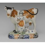 A James Emery Pottery Mexborough cow, calf and milkmaid group,