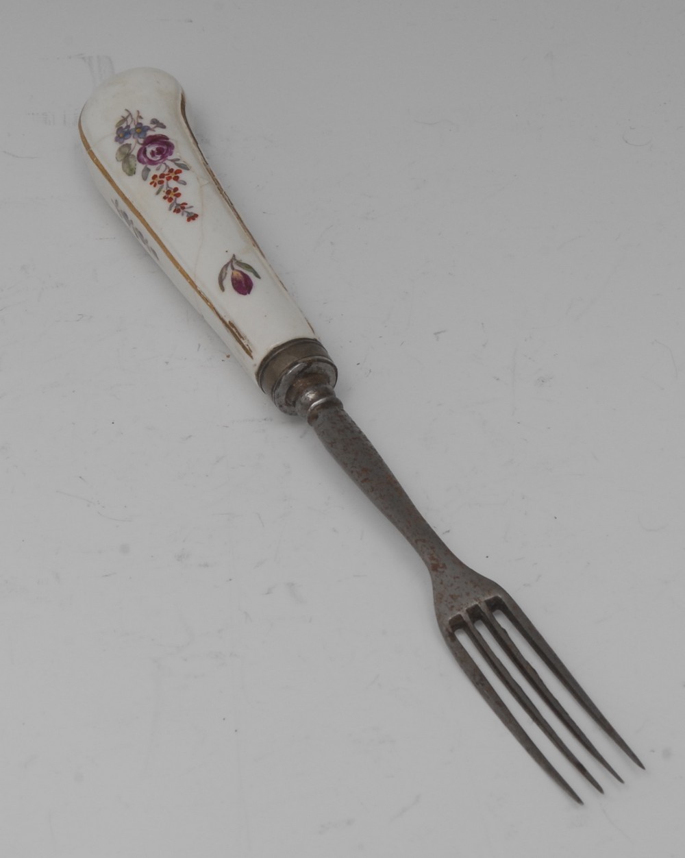 A Chelsea fork , the haft pained with Meissen type flowers, steel prongs, c.