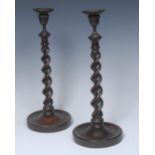 A pair of tall 19th century mahogany table candlesticks, brass urnular sconces,