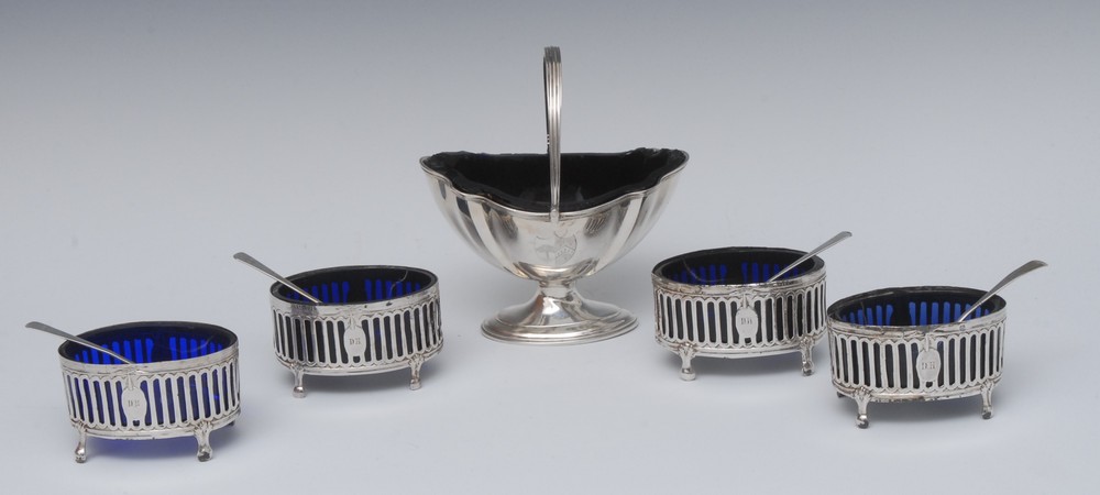 A George III silver Neoclassical urnular sugar basket, reeded swing handle, stepped oval base,