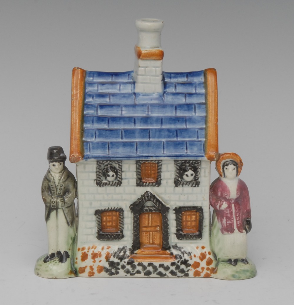 A Pratt Ware cottage money bank, with tiled cobalt blue roof, with ochre gables and central chimney,