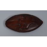 An early 19th century coquilla nut snuff box, hinged cover carved with a putto bearing a cross, c.