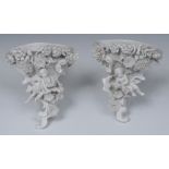 A pair of Sitzendorf blanc de chine wall brackets, encrusted with flowers and foliage,
