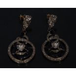 A pair of pave diamond encrusted blue enamelled sinuous scrolling and ring disc earrings,