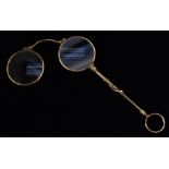 A late 19th century gilt metal long handled lorgnette,