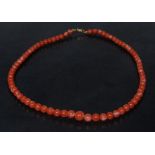 A graduated pink and white globular coral bead necklace, threaded base metal barrel clasp,