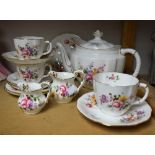 A Royal Crown Derby Posie pattern tea pot, two teacups, a breakfast cup, three saucers,