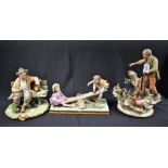 A Capodimonte ceramic figure group, Boy and Girl on See-Saw; others, Vagrant on Bench,