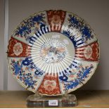 A large Japanese shaped circular charger, decorated in the Imari palette, 45cm diam,