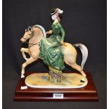 A Coalport ceramic figure of a female on horseback, La Promenade a Cheval,