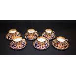 A set of six Royal Crown Derby 1128 pattern coffee cups and saucers