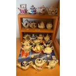 A quantity of miniature teapots, in various forms,