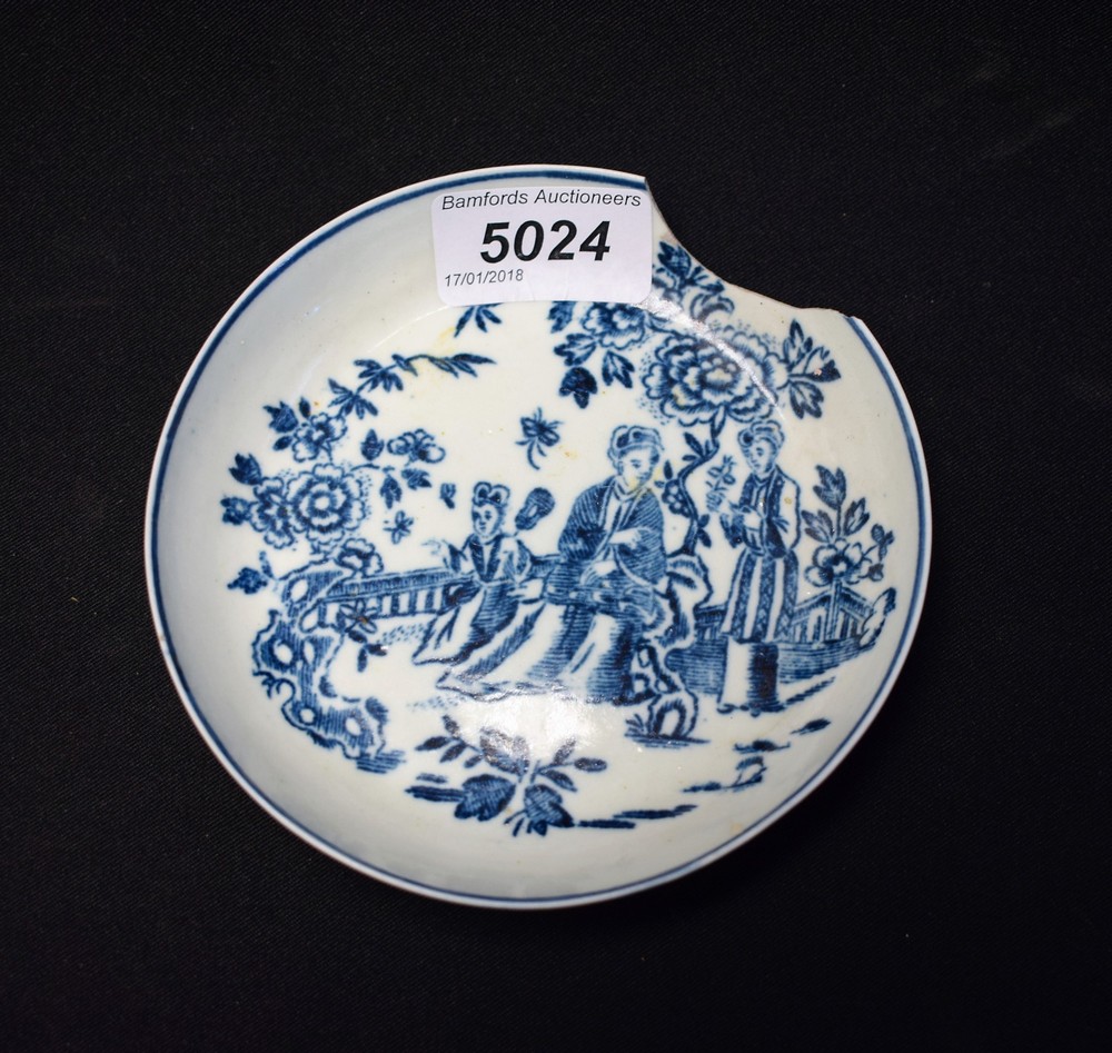 A Liverpool saucer, printed in blue with oriental figures in a garden setting,