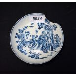 A Liverpool saucer, printed in blue with oriental figures in a garden setting,