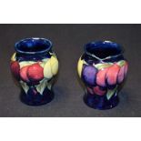 A pair of Moorcroft Wisteria pattern miniature inverted baluster vases, impressed marks, c.