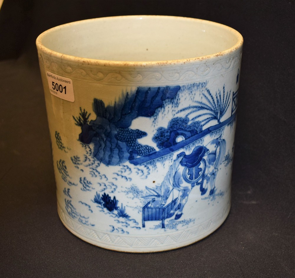 A Chinese cylindrical brush pot, painted in underglaze blue with scenes and figures from rural life,