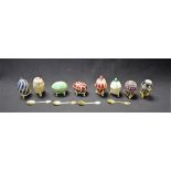 A set of eight base metal Russian style collector's eggs, enamelled and applied with glass stones,