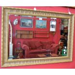 A large rectangular gilt framed mirror, bevelled edge,