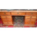 A mahogany pedestal desk, inlaid leather top,