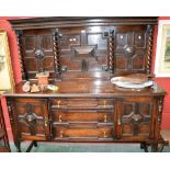 A Jacobean Revival oak sideboard, gallery with block fronted panels flanked by barley twist columns,
