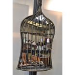 A wall mirror in the form of a birdcage.