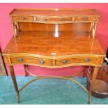 A reproduction yew wood Serpentine front lady's writing desk by EG Hudson, Worthing, Sussex,