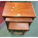 An oak nest of three tables