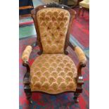 A Victorian carved mahogany balloon back open arm elbow chair