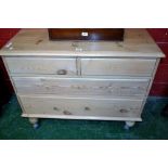 A stripped pine chest of two short drawers over two graduated long